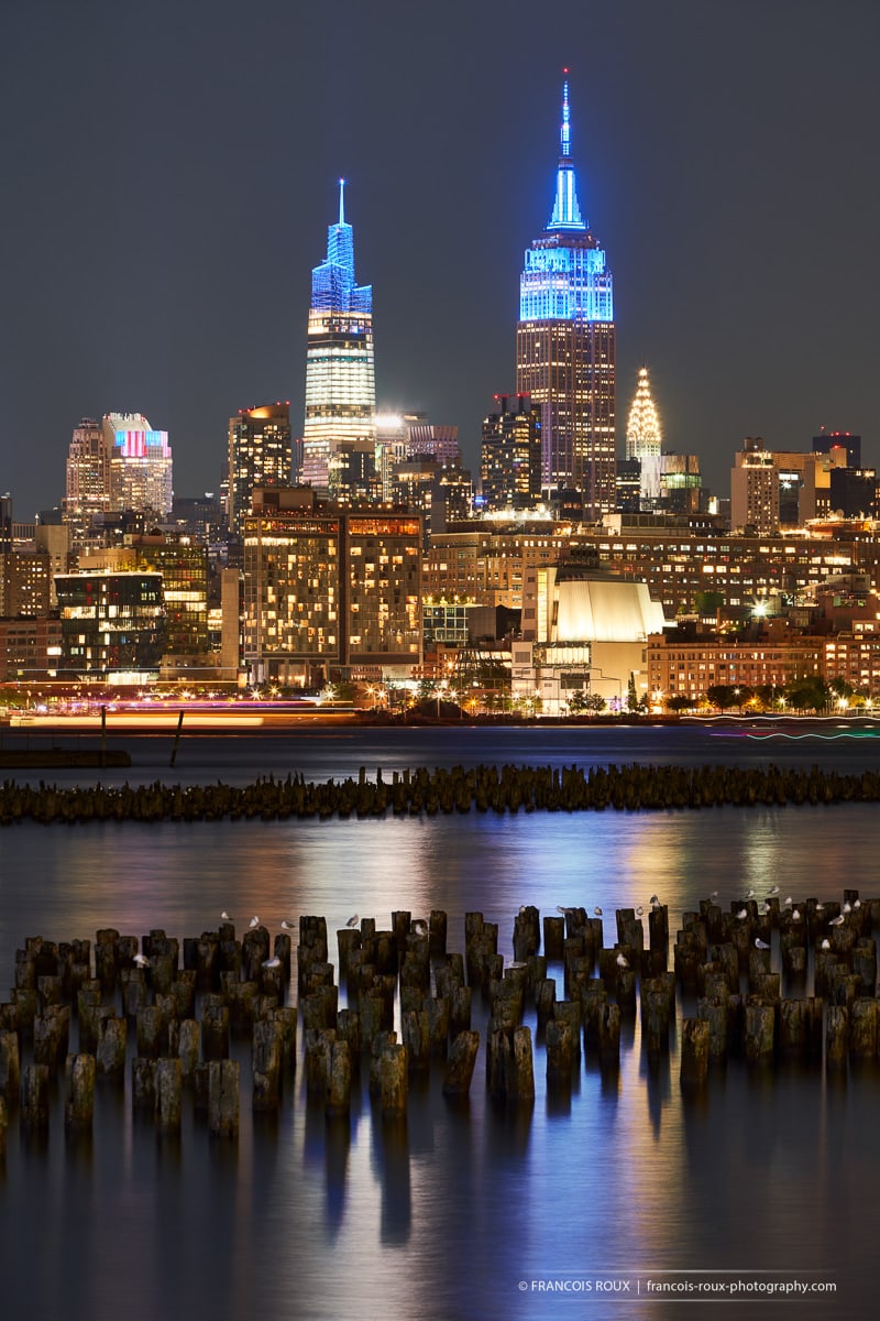 Photo of the Empire State Building and One Vanderbilt skyscrapers at night with Hudson River. New York City - Francois Roux Photography